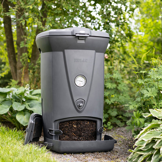 Gray compost bin with a visible brand logo in a garden setting