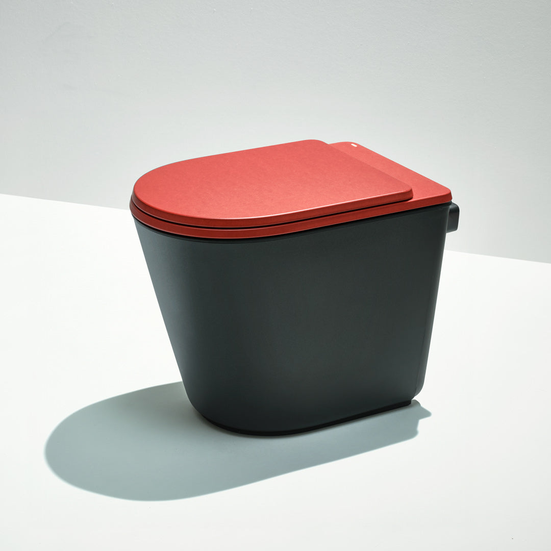 Black toilet with a red lid on a white background